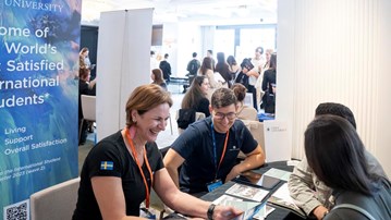 University staff talking to prospective students.