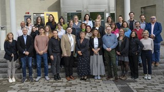 Group photo of EC2U university delegates in front of a campus building