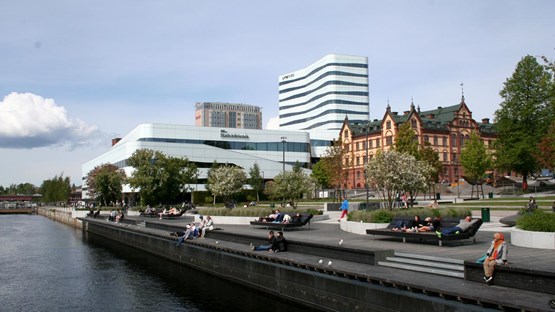 Umeå centre from the river with a park and the cultural centre in the background.