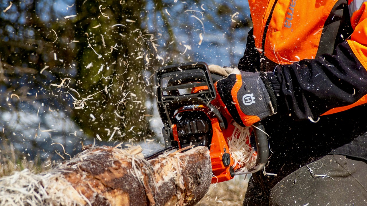Chain saw working on a log