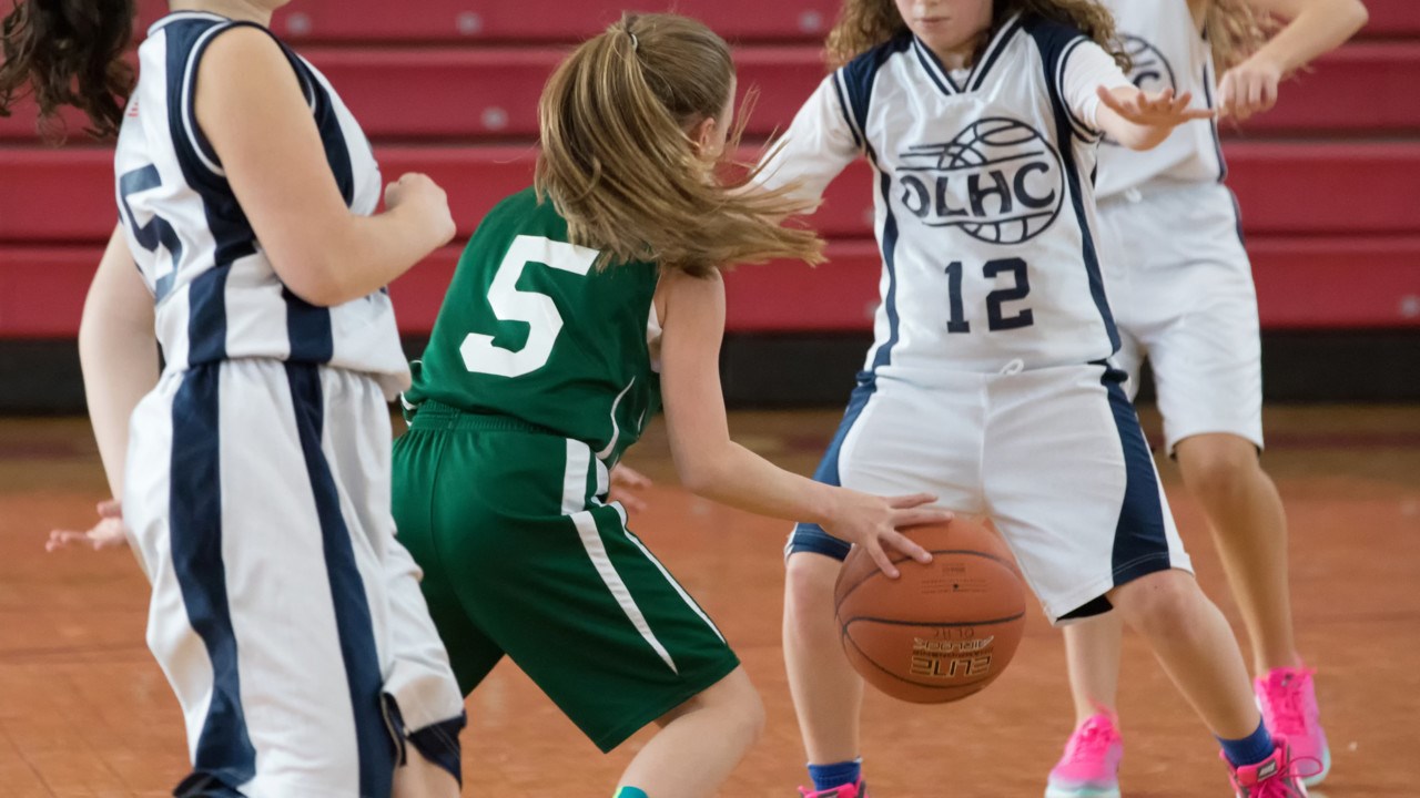 Ungdomar som spelar basket.