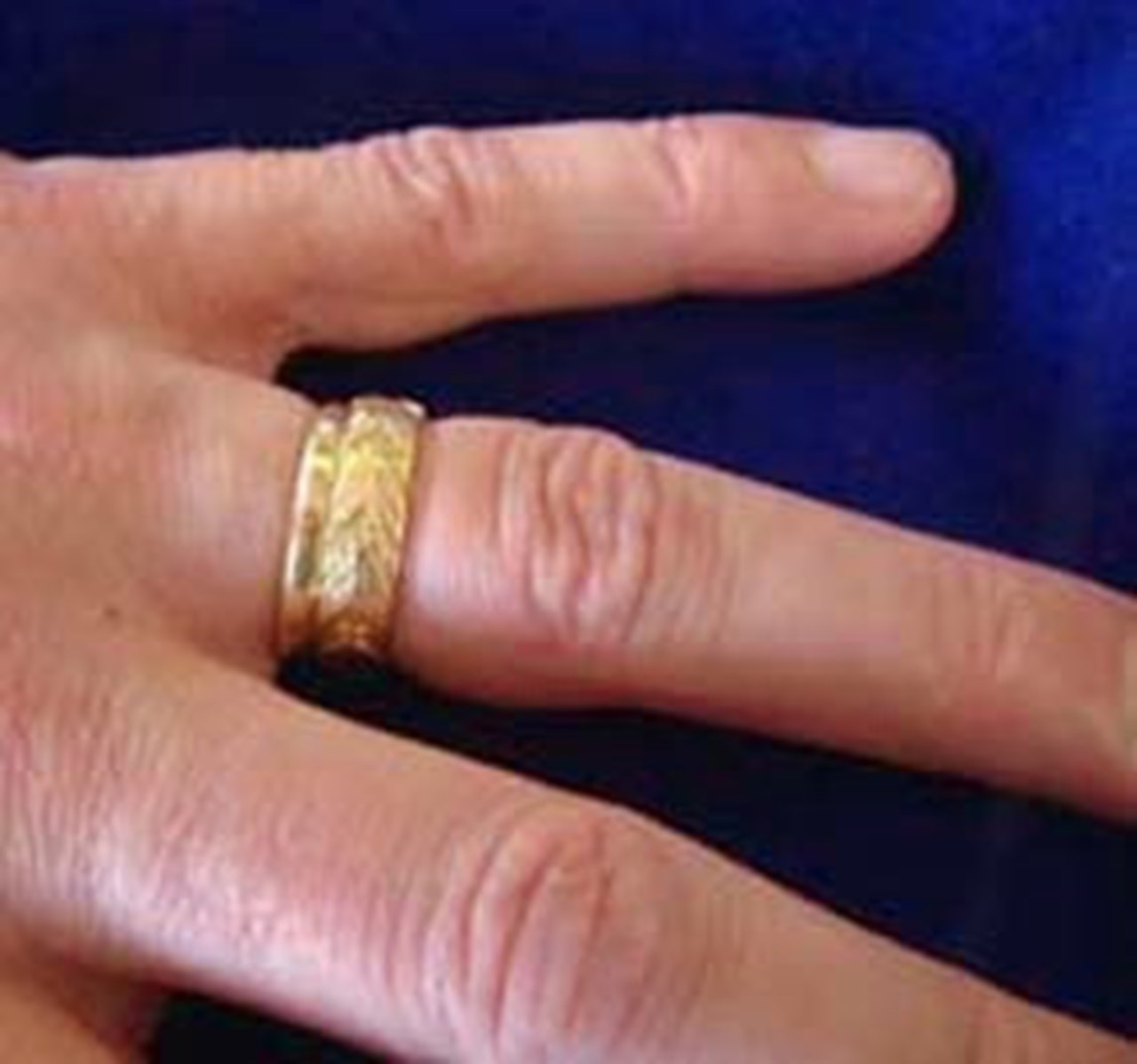 Photo of a wedding ring inside a doctoral ring.