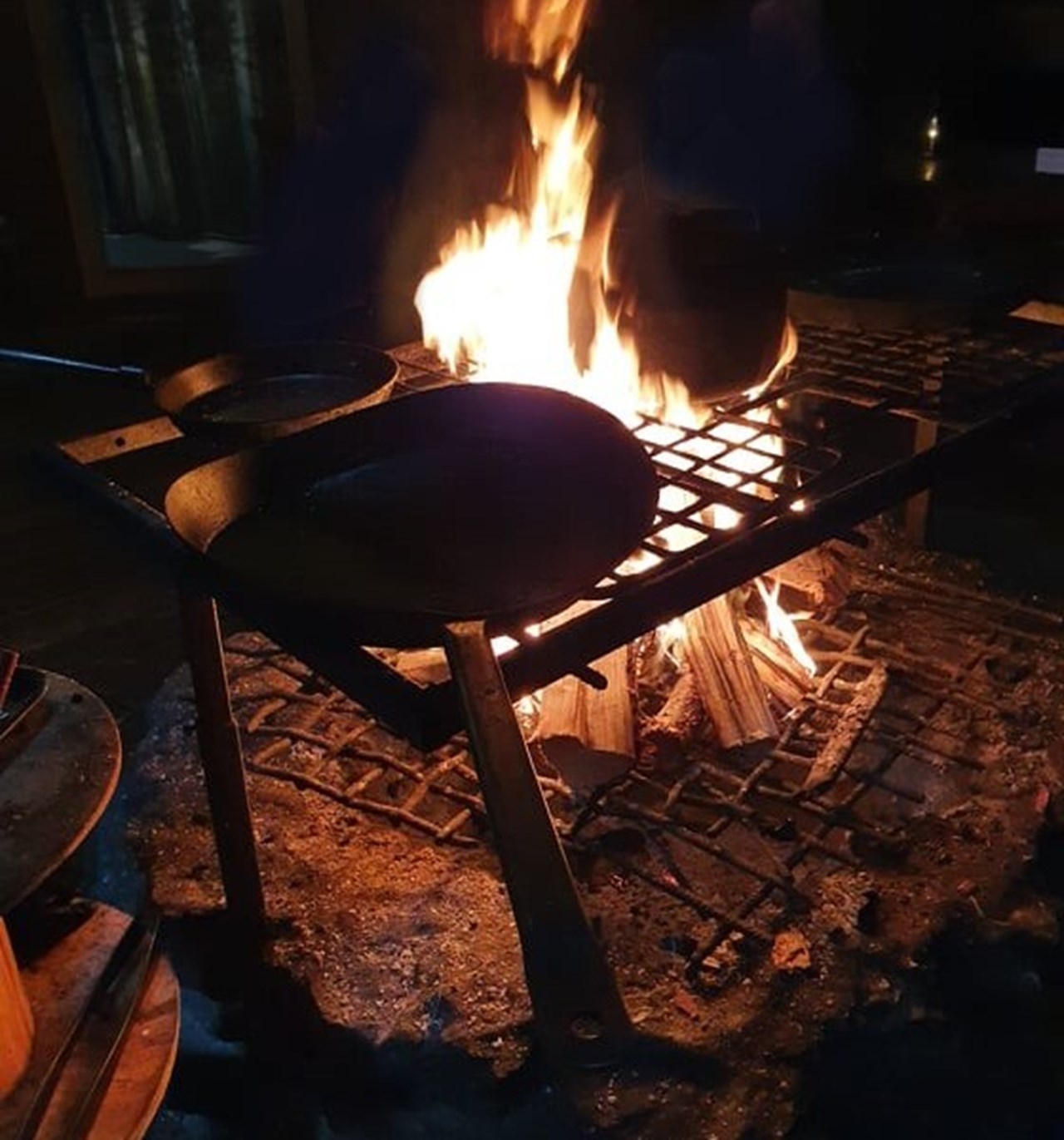 Pots on grill above open fire