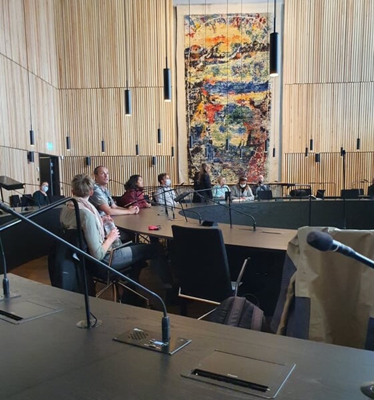 A handful of participants sit around a desk circle in the new town hall in Kiruna