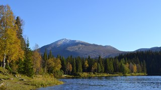Photo of a lake with a mountain in the background