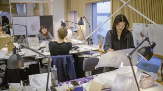 Photo of students working at their desks in Umeå School of Architecture