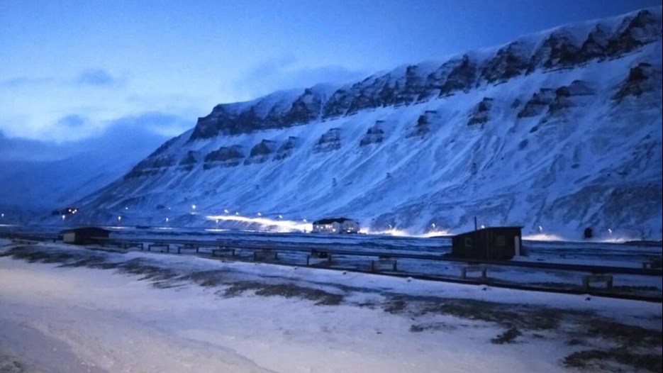 Snöiga berg i Svalbard, i gryningsljus