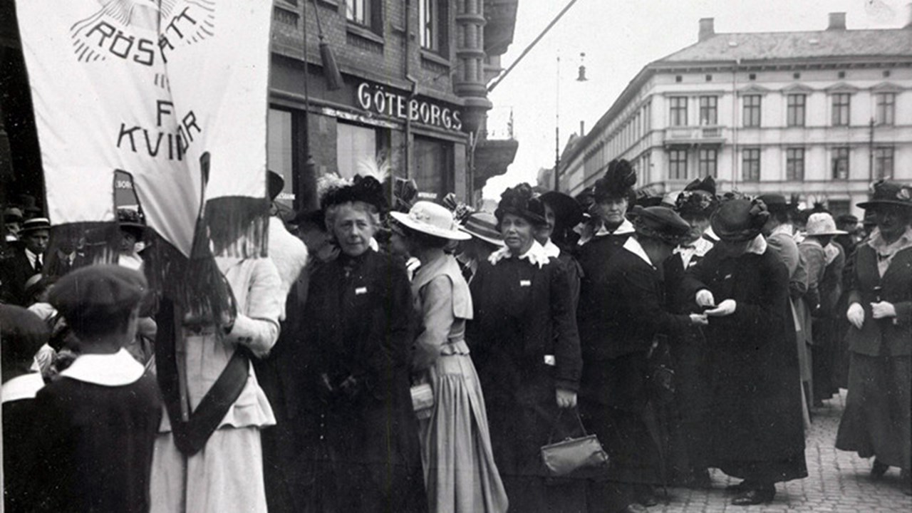 Svartvitt foto på ett demonstrationståg för kvinnors rösträtt i centrala Göteborg 1918