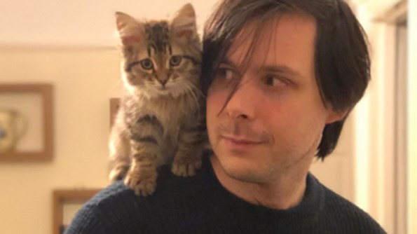Fintan Mallory with a kitten on his shoulder