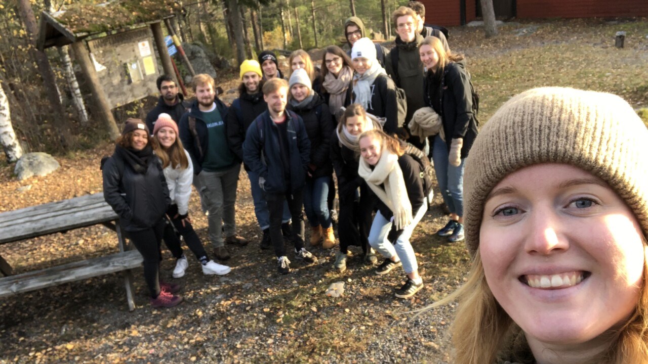 Emma, buddy coordinator, with a buddy group in the background