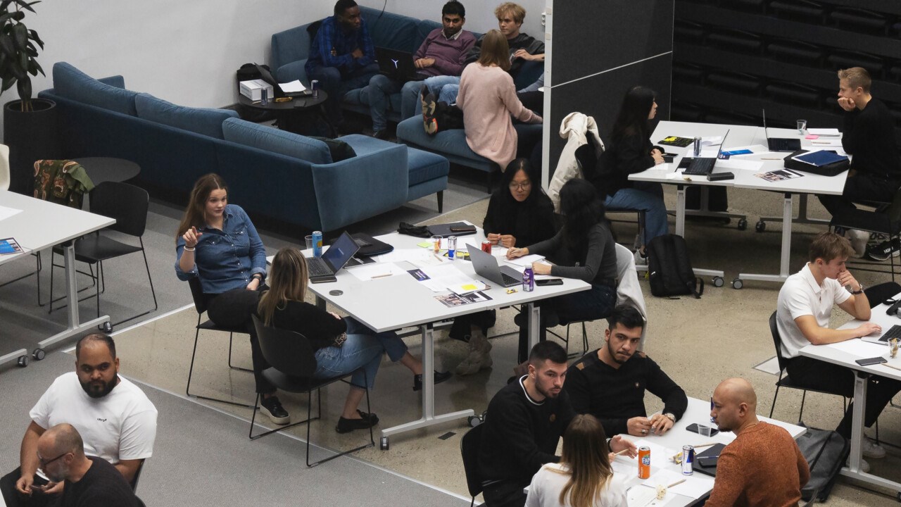 People sitting in groups and working together