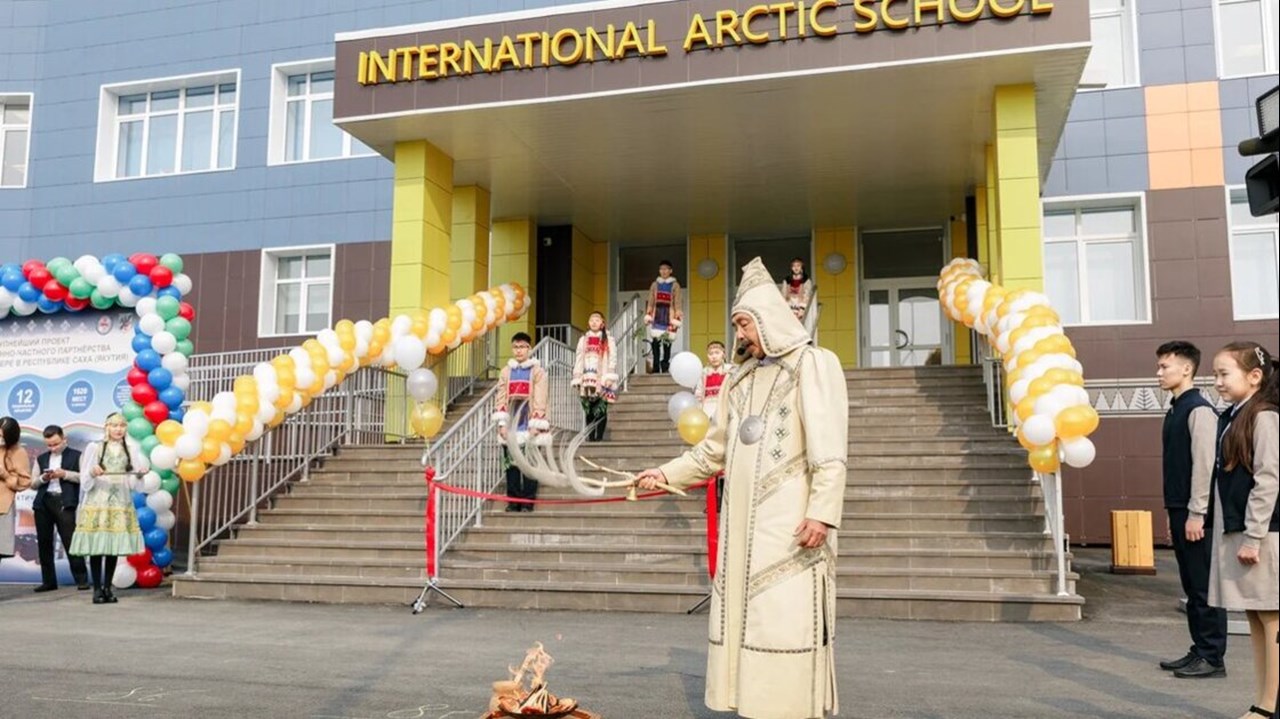 Inauguration ceremony. In the background on the stair stands students in traditional clothing