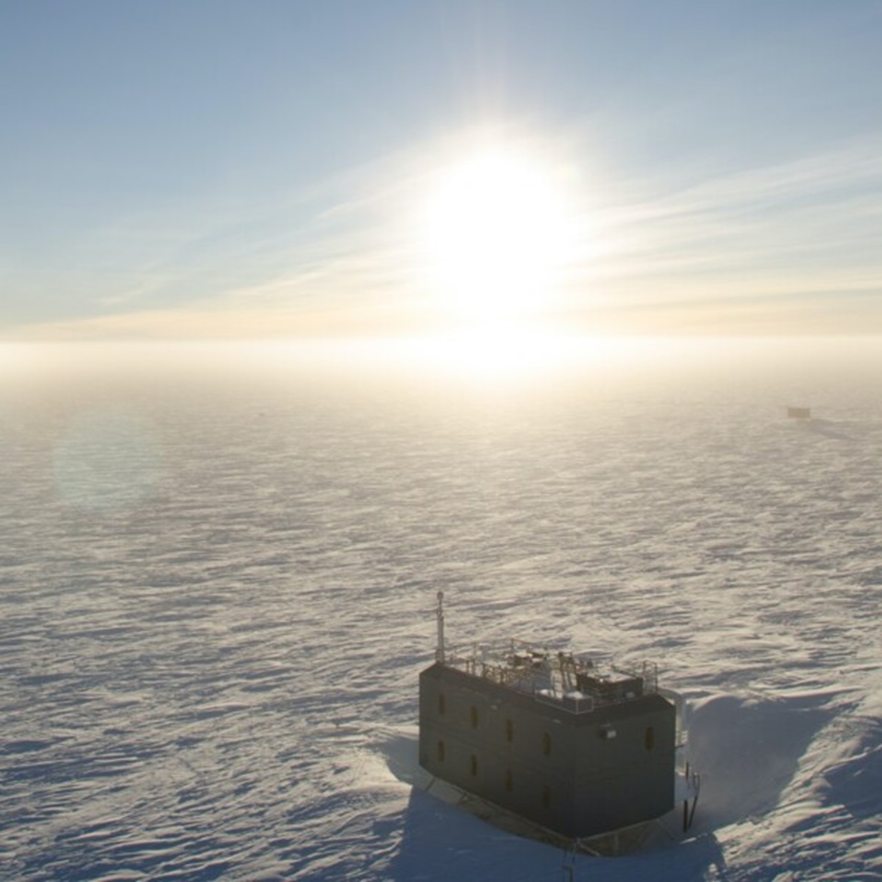 The sun has risen a few degrees above the horizon at an atmospheric research observatory, South Pole, Antarctica