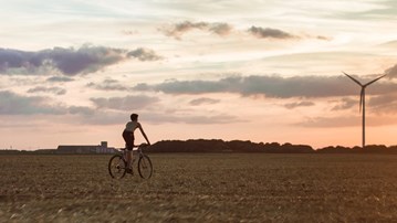 någon cyklar genom ett landskap