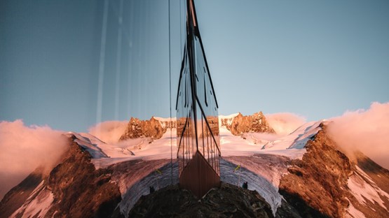 alpine peak reflected in glass windows