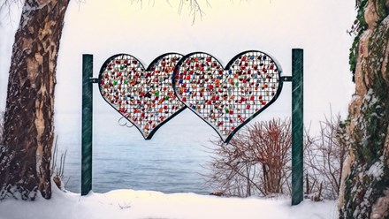 Art of hearts near a river in winter landscape