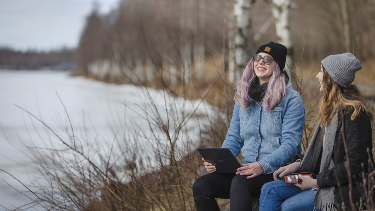 Evelinn Carlsson and Tinah Ekwall students study by the river.