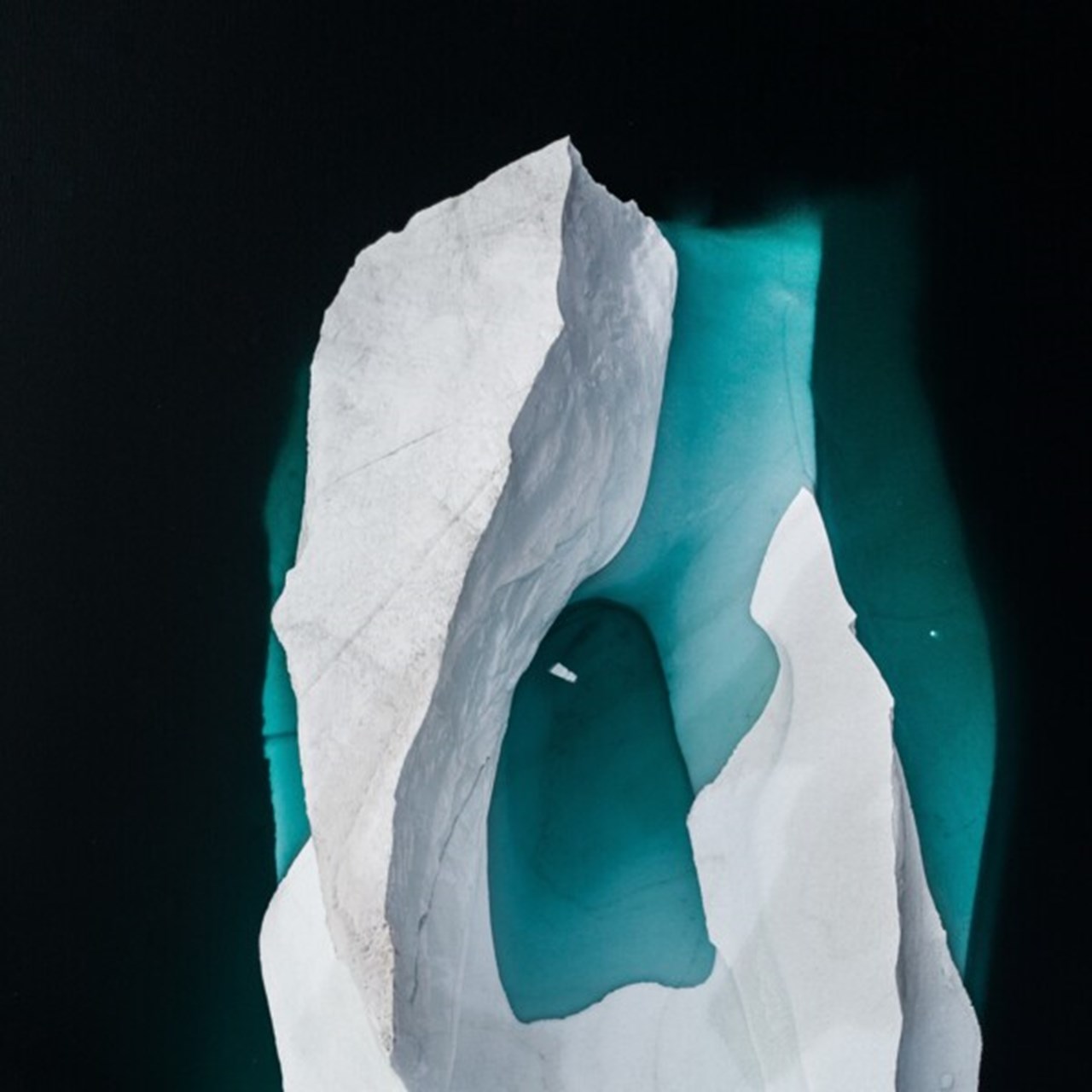 Icebergs from above in dark water