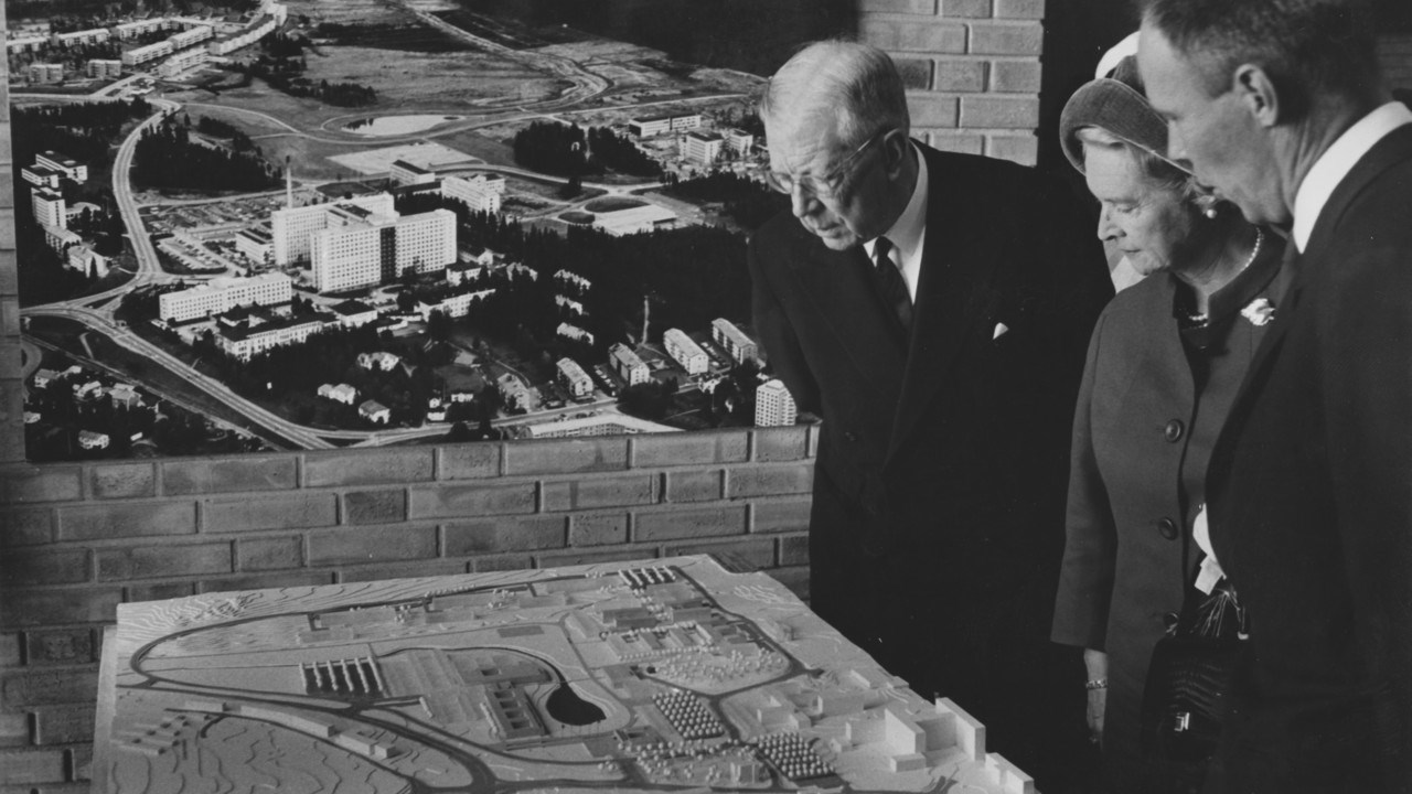 Rektor L-G Larsson visar en modell över universitetsområdet för kung Gustaf VI Adolf och prinsessan Sibylla, vid universitetets invigning 1965.