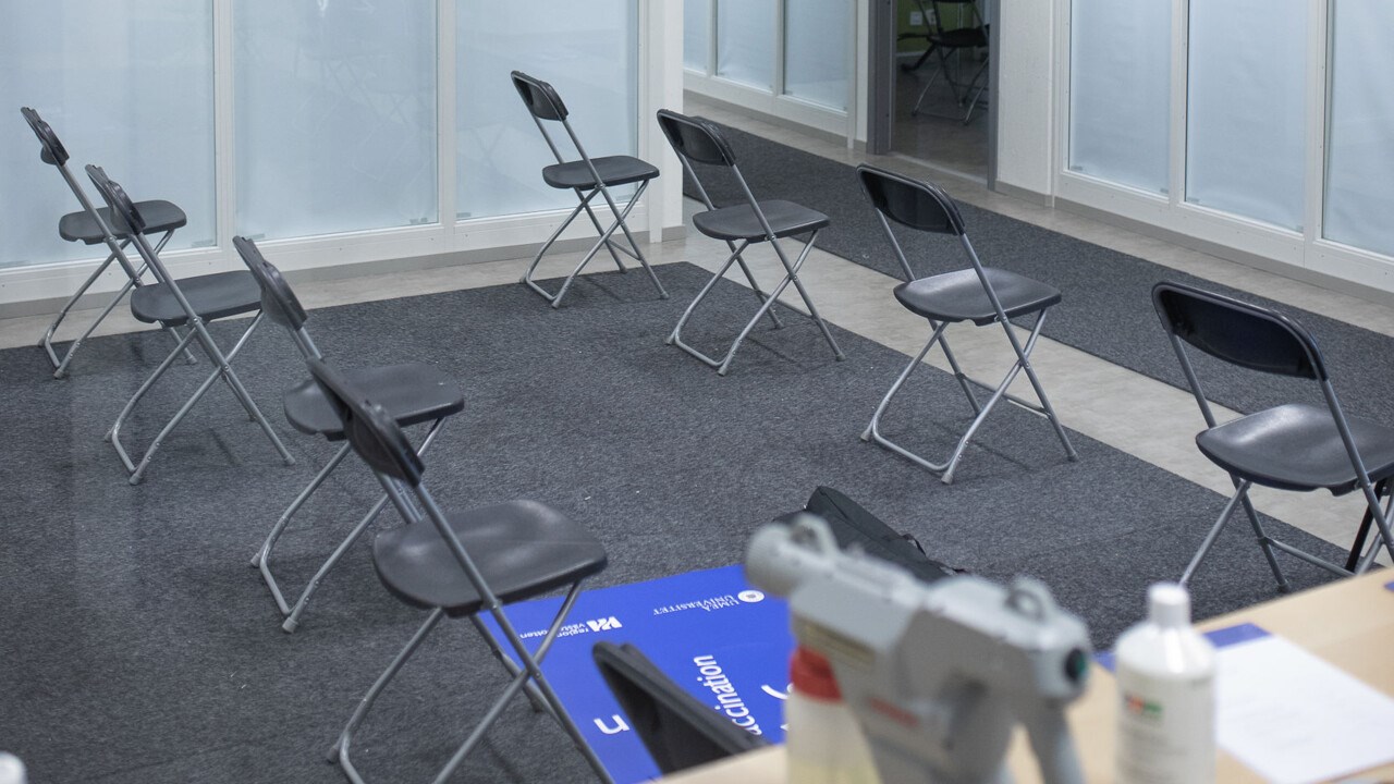 Photo of a waiting room with empty chairs where vaccinated wait after their jab.