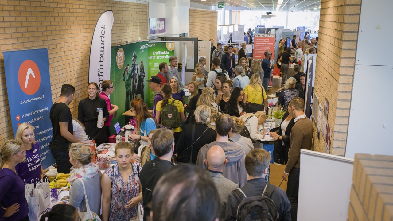 A corridor full of people and exhibitors.