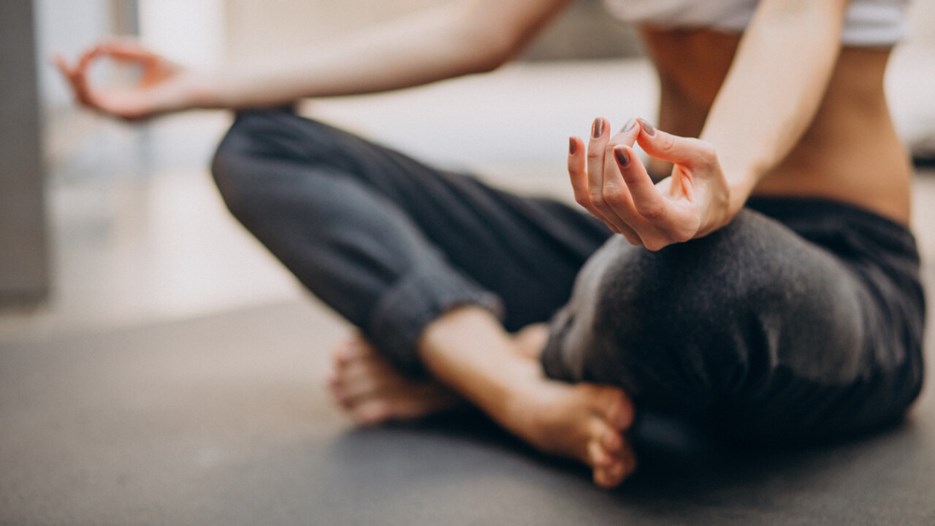 Young woman sitting and meditating