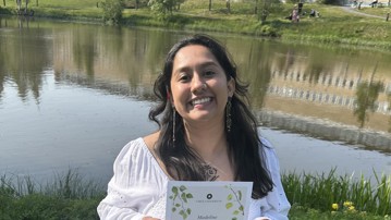 Madeline Morales with her Master's diploma after completing the Master's programme in Environmental Science.