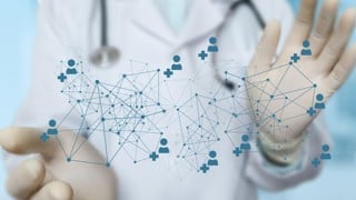 Doctor shows a medical network on a blurred background.