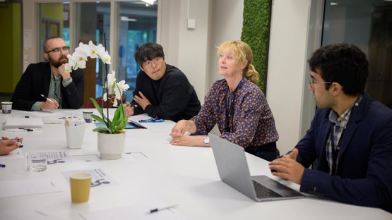 Professor Åsa Strand discusses a new project idea in plant stress response modeling with other researchers, including Seong-Gyu Yang, IceLab and Department of Physics postdoctoral fellow.