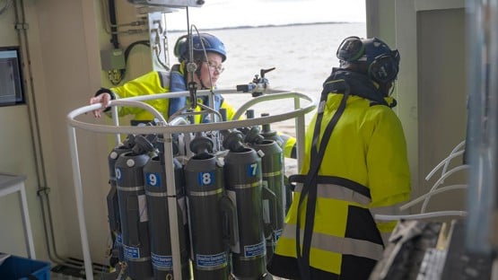 Two persons working onboard a research vessel