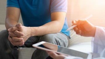 Men's health disease, on prostate cancer or mental illness concept with male patient having consultation with doctor or psychiatrist working on diagnostic examination in medical clinic or hospital