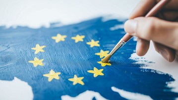 En person målar en EU-flagga.