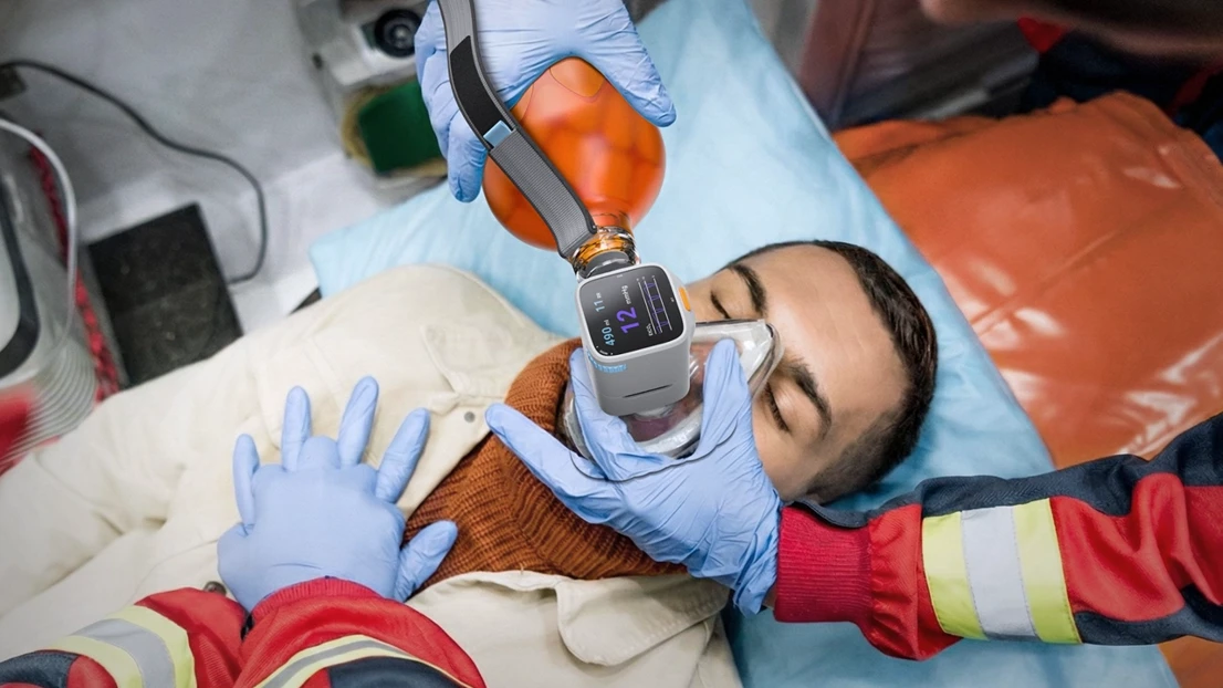 A man laying on a bed with a cell phone in his hand.