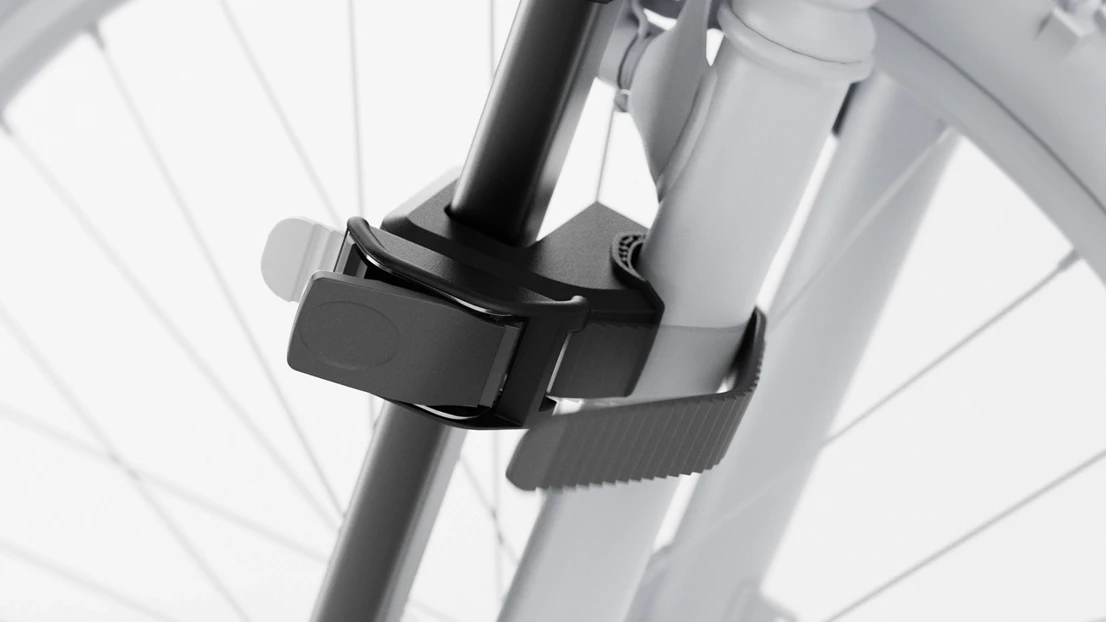 The straps are tightened around the front of the kid’s bike.