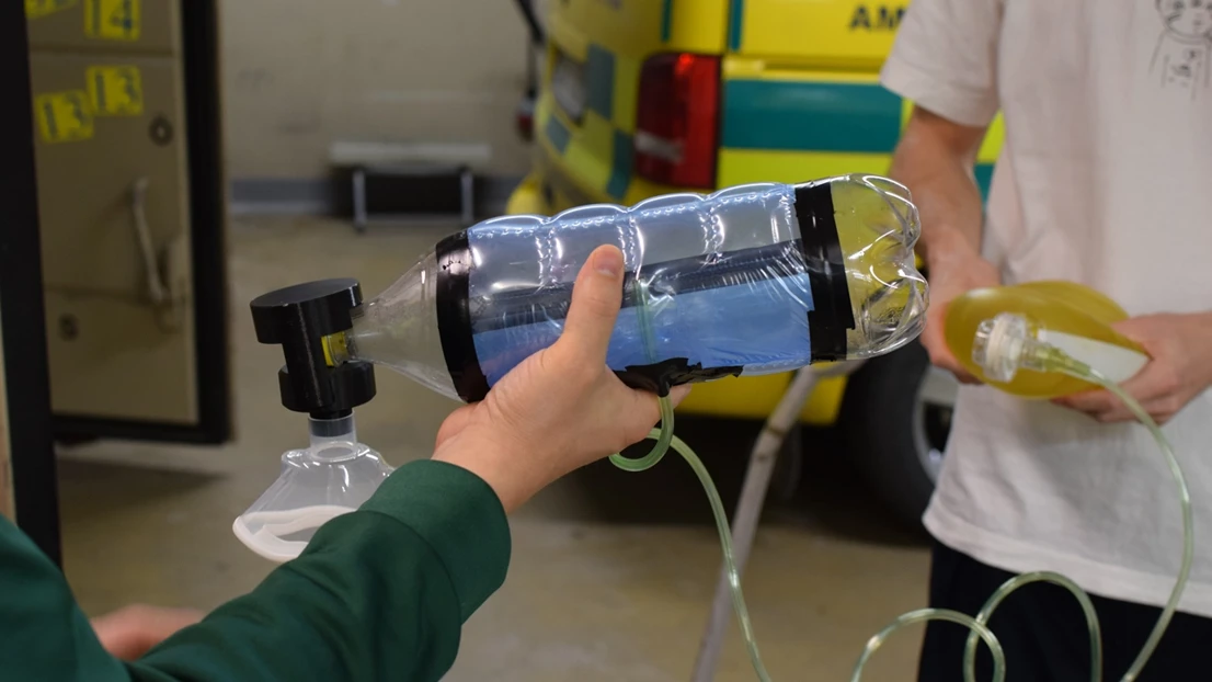 A person is pouring water into a water bottle.