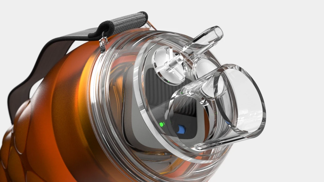 A close up of an orange and black object on a white background.