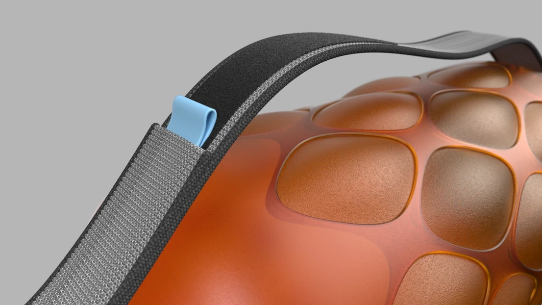 A close up of an orange object with a black strap.