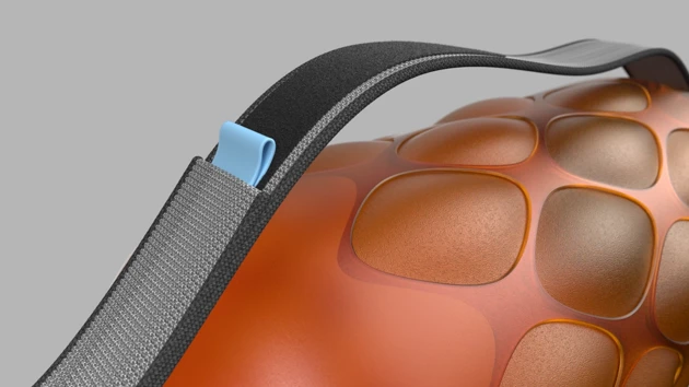 A close up of an orange object with a black strap.