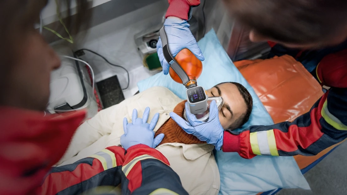 A man laying in a hospital bed with an oxygen mask on.