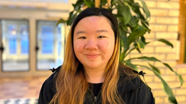A female student inside one of the buildings on Campus Umeå.