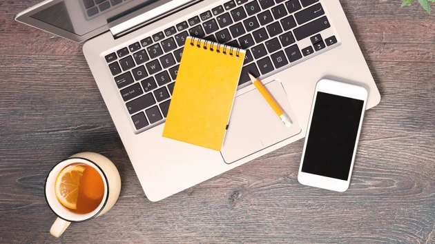 A laptop, a cell phone, a notebook and a pencil. 