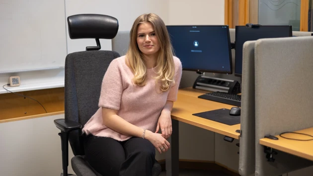 Bild på Elin Blomkvist sittande vid datorarbetsplats