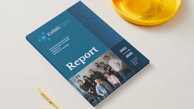 A report book sitting on top of a table next to pencils.