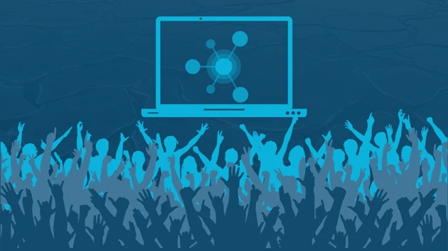 En grupp människor som står framför en bärbar dator