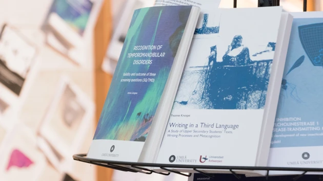 Book stand with theses from Umeå University