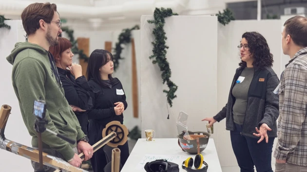 A group of people standing around a table.