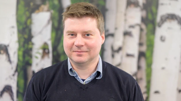 Photo of Jonas Westin, wall with birch motif in the background