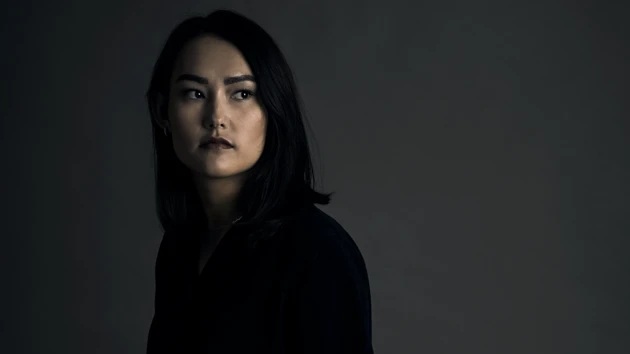 Portrait photo of Kim Onchoi Stenmark against a dark background