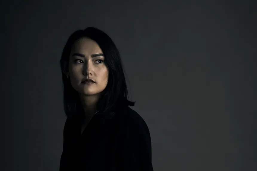 Woman standing in front of a black wall