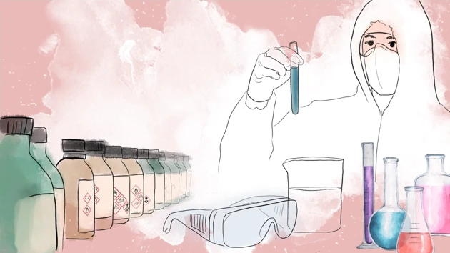 Person with full safety equipment holding a test tube in a lab. 